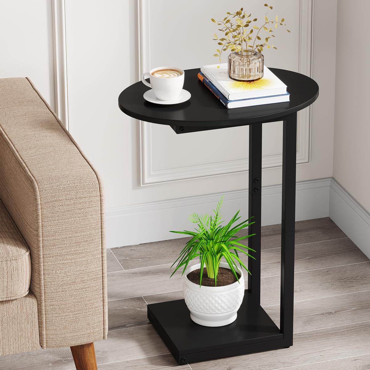 Hosfais small side table with oval C-shape in black beside the sofa for easy reach