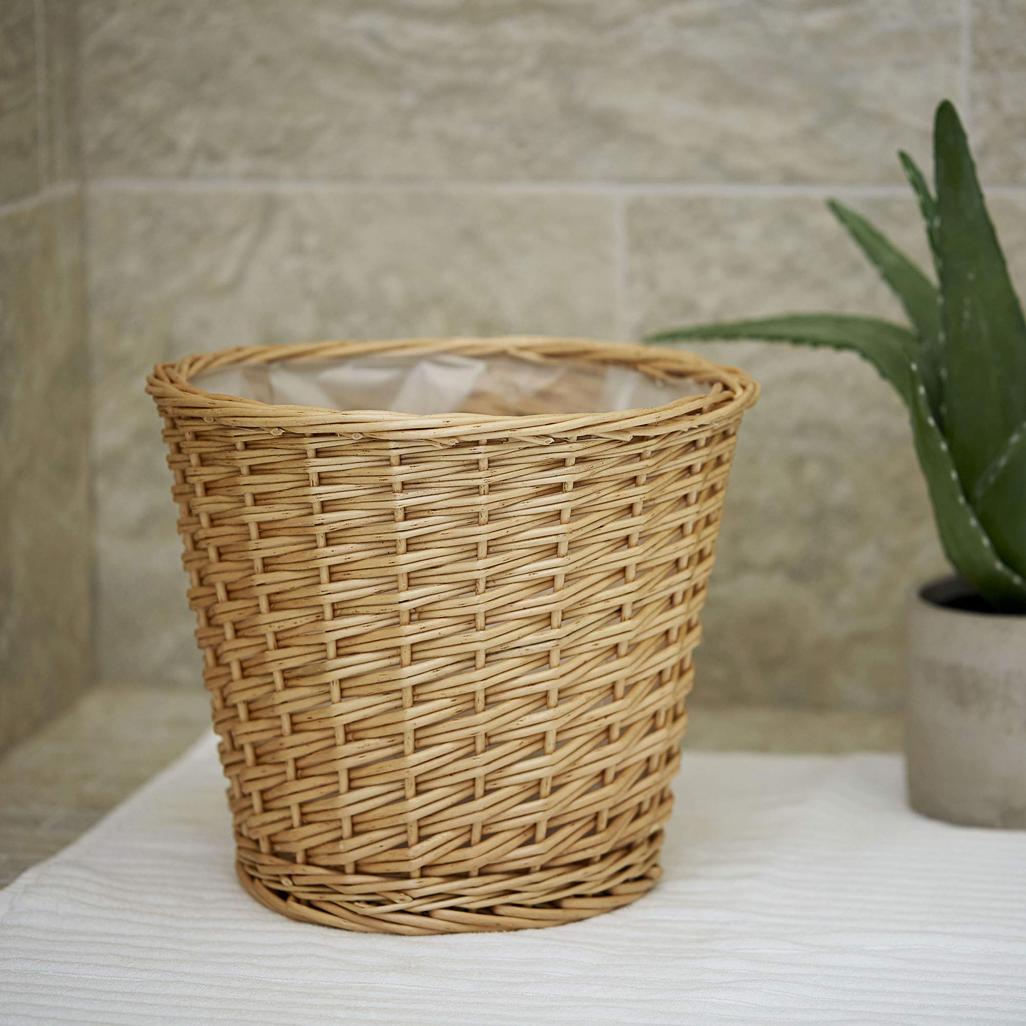 Household Essentials Willow wicker waste basket room setting demonstrates versatile placement