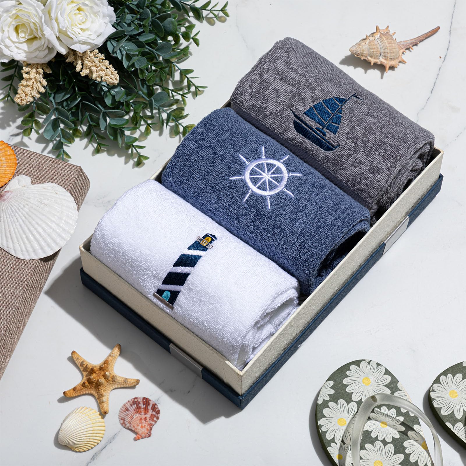 HunnmingRe sailboat-embroidered towel enhances bath area with nautical flair.