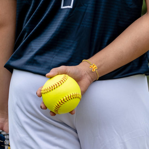 Detail view of the bow-shaped softball element with gold beads