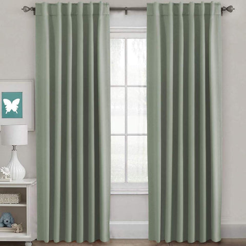 H.VERSAILTEX blackout curtains light sage pair of panels framing a window for enhanced privacy.