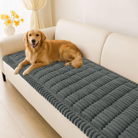Hyha couch cover on a dark grey sofa protecting upholstery with pets