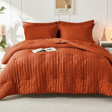 HYMOKEGE Burnt Orange Queen Comforter in a cozy bedroom scene expressing warmth