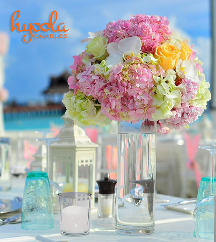 Hyoola votive candles glow on dining surface to enhance atmosphere