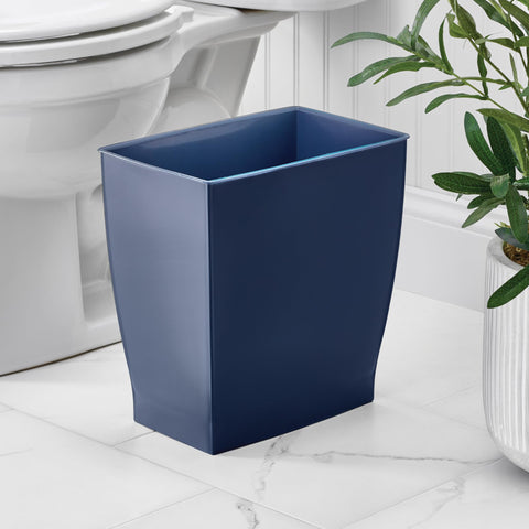 iDesign Mono trash can in navy blue in a bathroom vanity keeps disposal discreet.
