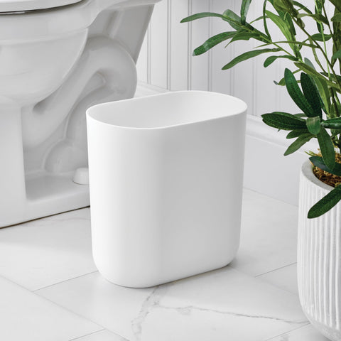 iDesign slim trash can on a desk keeps waste tidy in busy offices