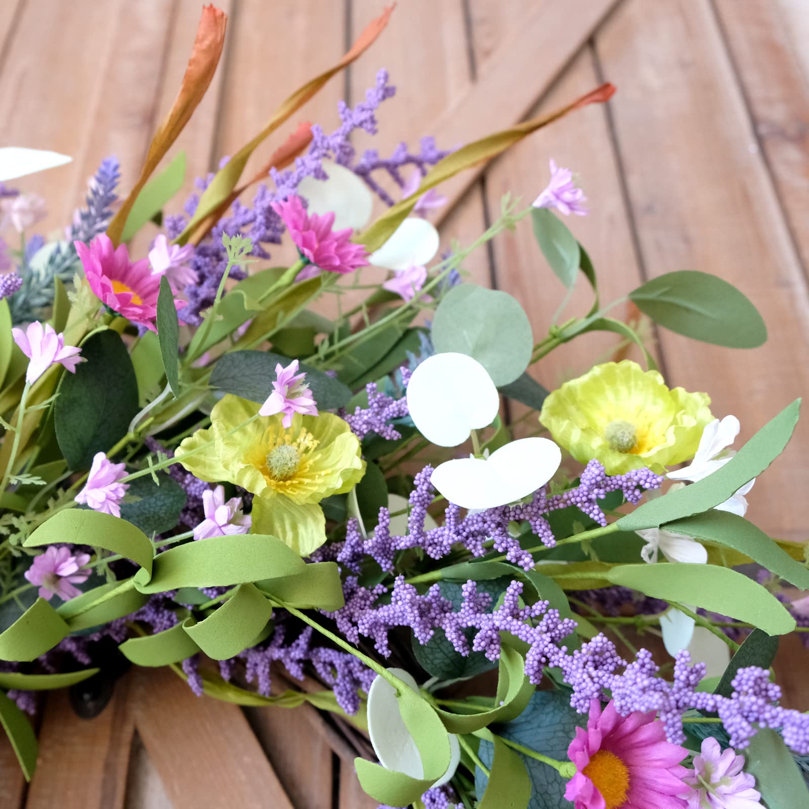 Idyllic rustic farmhouse wreath complements cozy entryways with natural grapevine backing.