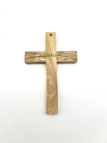 Cross with visible grain texture highlights unique wood patterns for sacred decor.
