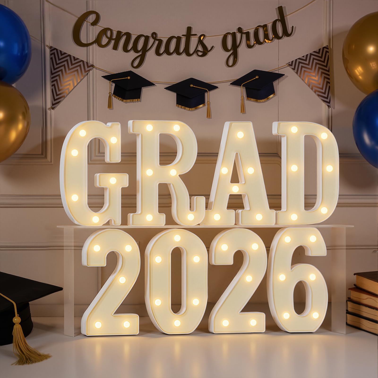 imprsv Grad 2026 letters illuminate a festive graduation display.