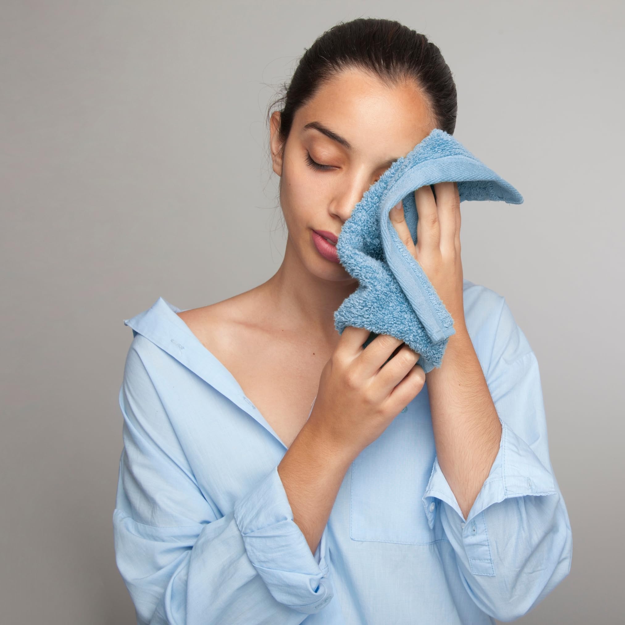 Infinitee Xclusives gym spa washcloth use shown as a sweat-friendly workout companion.