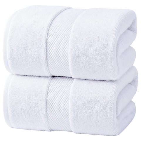 Infinitee Xclusives jumbo bath sheets rolled for compact storage and quick drying.