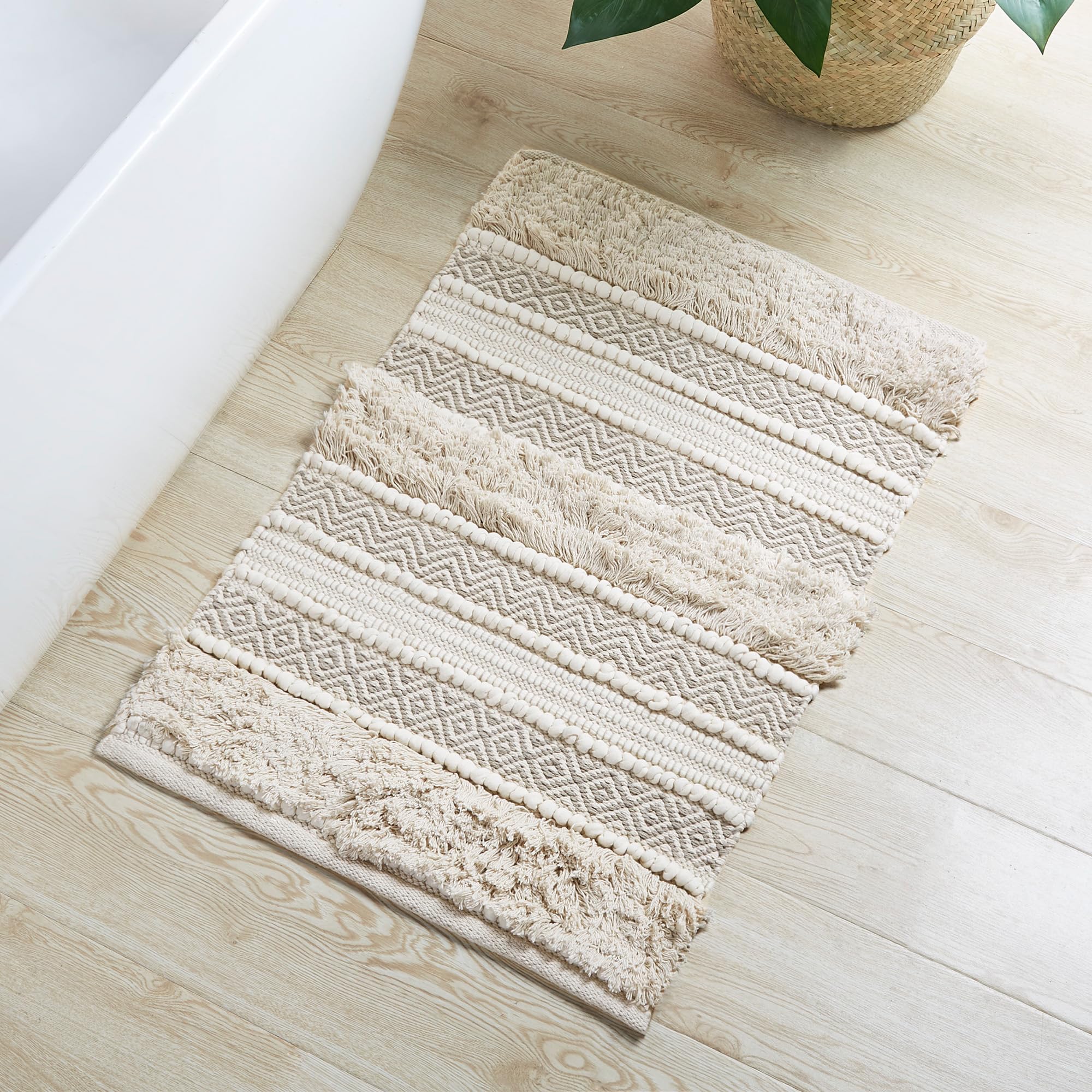 INK+IVY Asher bath rug with woven texture stripe adds chic boho style.