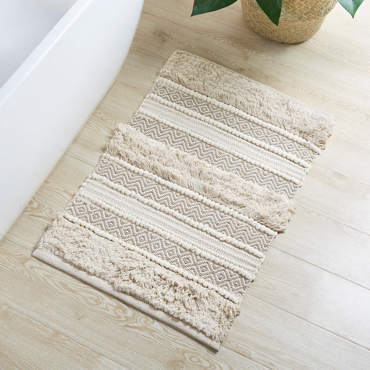 INK+IVY Asher bath rug with woven texture stripe adds chic boho style.