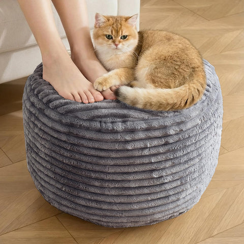 INSPIRE CRAFTER round pouf ottoman in dark grey corduroy serves as a stylish footrest