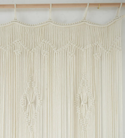 IOWER macrame curtain room divider provides subtle, stylish separation.