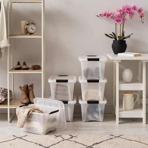 IRIS USA six-pack stackable storage bins on a shelf for space saving.