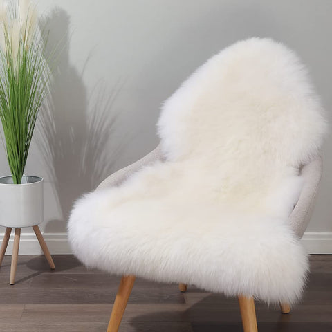 IRIWOOL sheepskin rug draped on a chair for plush seating.
