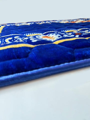 Islamika folded royal blue rug ready for travel and prayer.