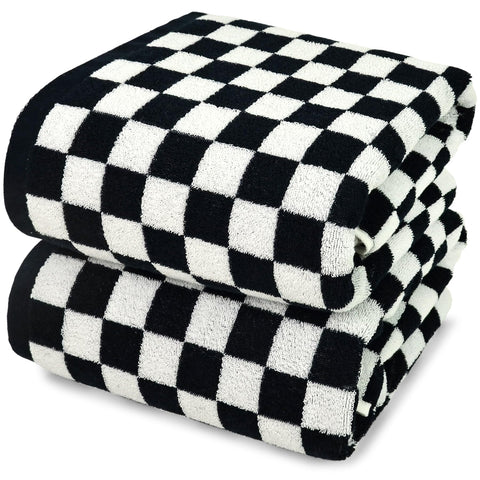 Jacquotha bath towels in black-white checkered folded, plush and absorbent.