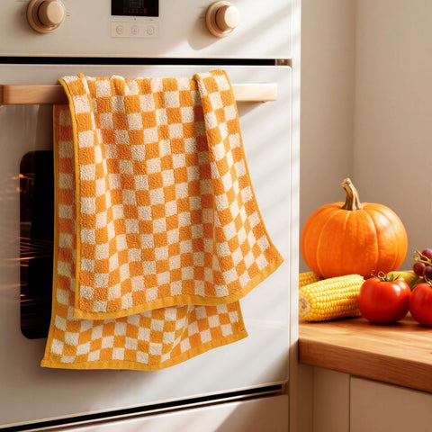 Jacquotha 13x29 towels, vibrant orange checkered design brightening any kitchen or bath.