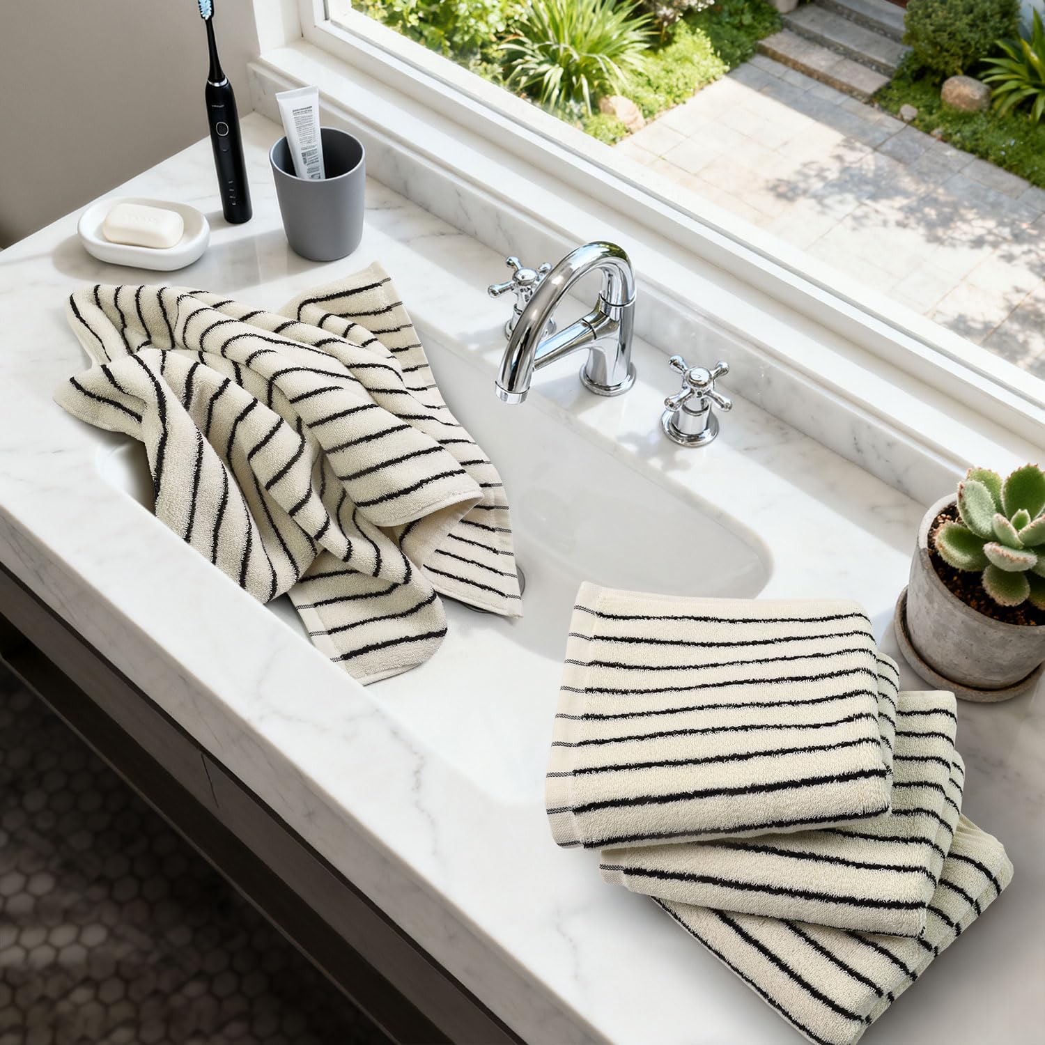 Jacquotha ivory striped towels add chic decor to any space.