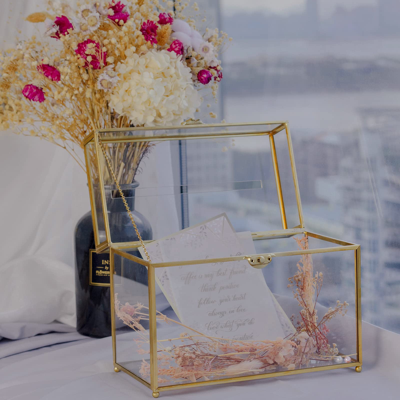 Jajamy clear card box with gold brass frame enhances wedding decor.