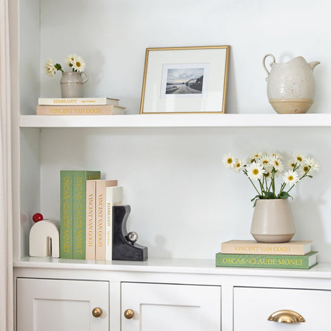 JARLINK coffee table display with faux books invites touch and conversation.