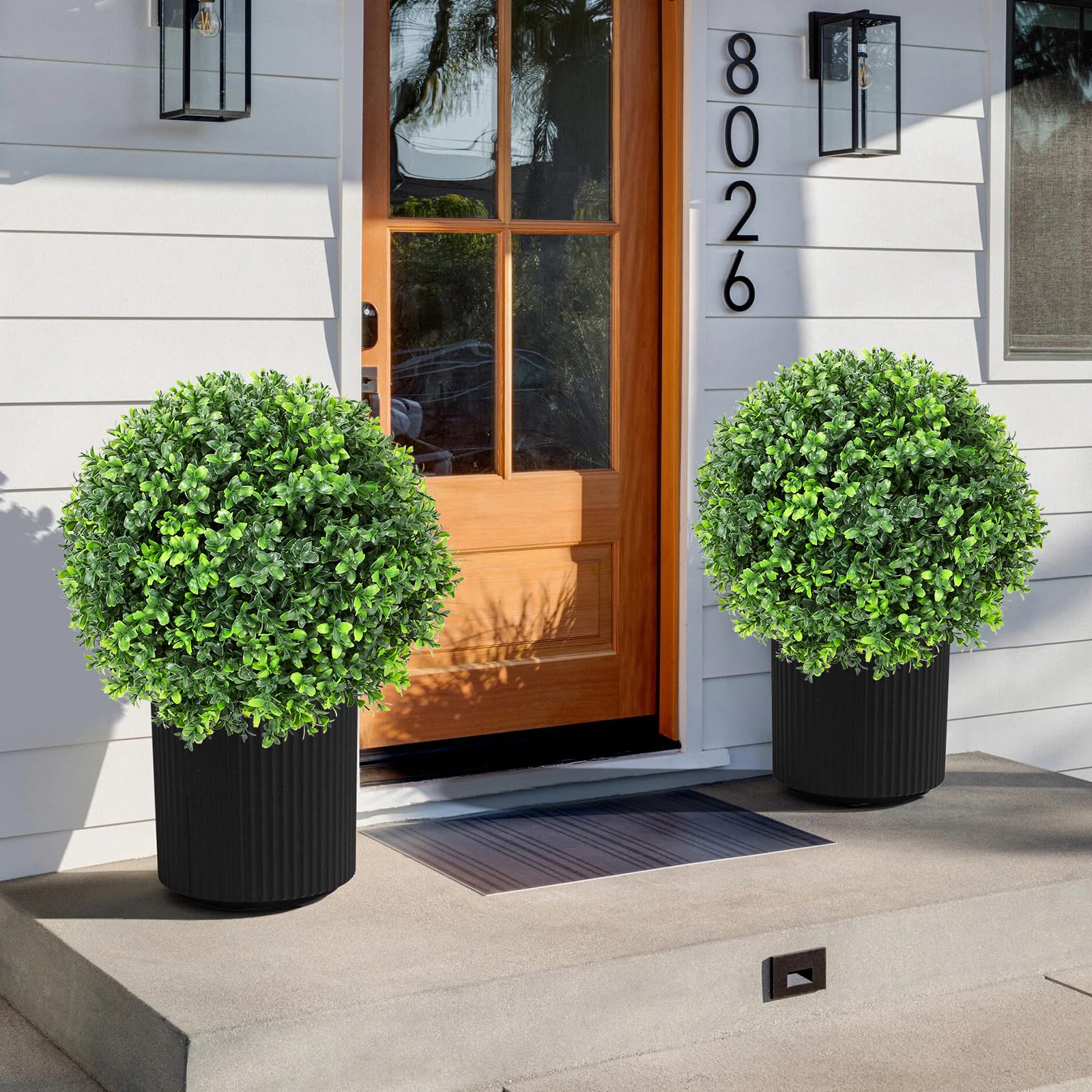 Jasmpig indoor outdoor faux greenery enhancing porch or living space.