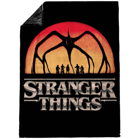 Jay Franco Stranger Things plush throw shows shadow monster over silhouettes for dramatic style.