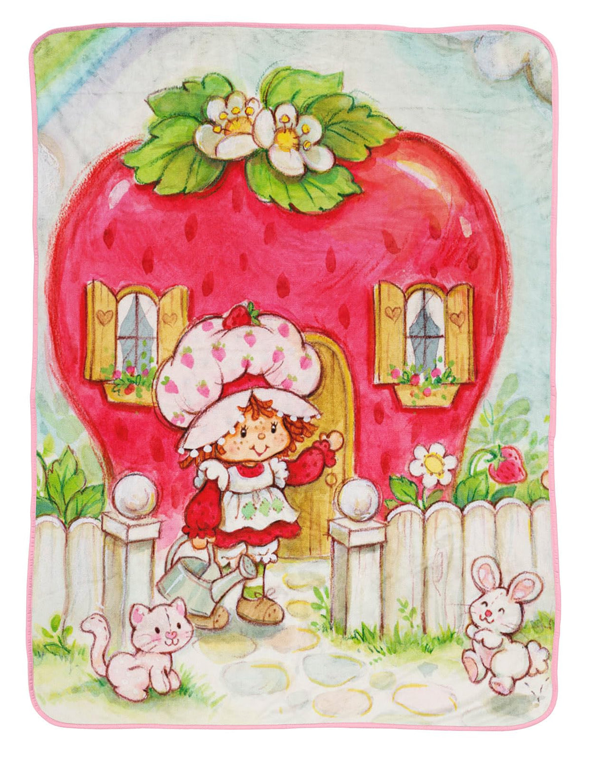 Jay Franco Strawberry Shortcake plush throw blanket on sofa for cozy evenings.