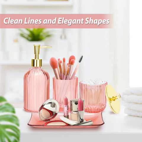 Jenseits pink apothecary jars with lids keep cotton rounds organized.