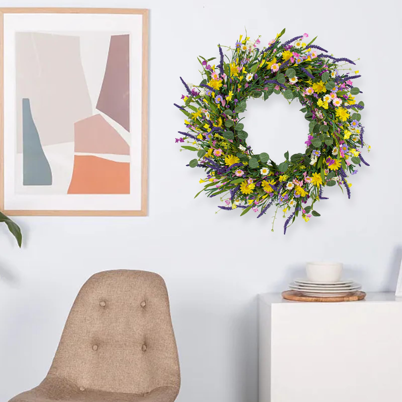 Close view of J'FLORU wreath on indoor wall showing vibrant flowers.