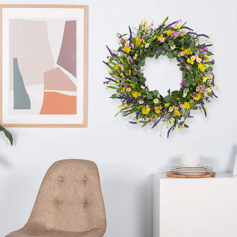 Close view of J'FLORU wreath on indoor wall showing vibrant flowers.