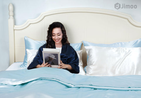 J JIMOO sleep setup in bed with light blue silk evokes luxury and calm.