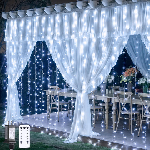 JMEXSUSS 300 LED curtain lights drape a room with warm white glow for cozy ambience.