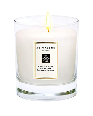 Jo Malone English Pear & Freesia candle lit to create a warm, cozy ambiance.