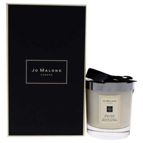 Jo Malone Wood Sage and Sea Salt candle in the jar enhances coastal luxury ambiance.