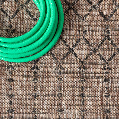 Jonathan Y outdoor rug on patio entrance showcases natural and black motif.