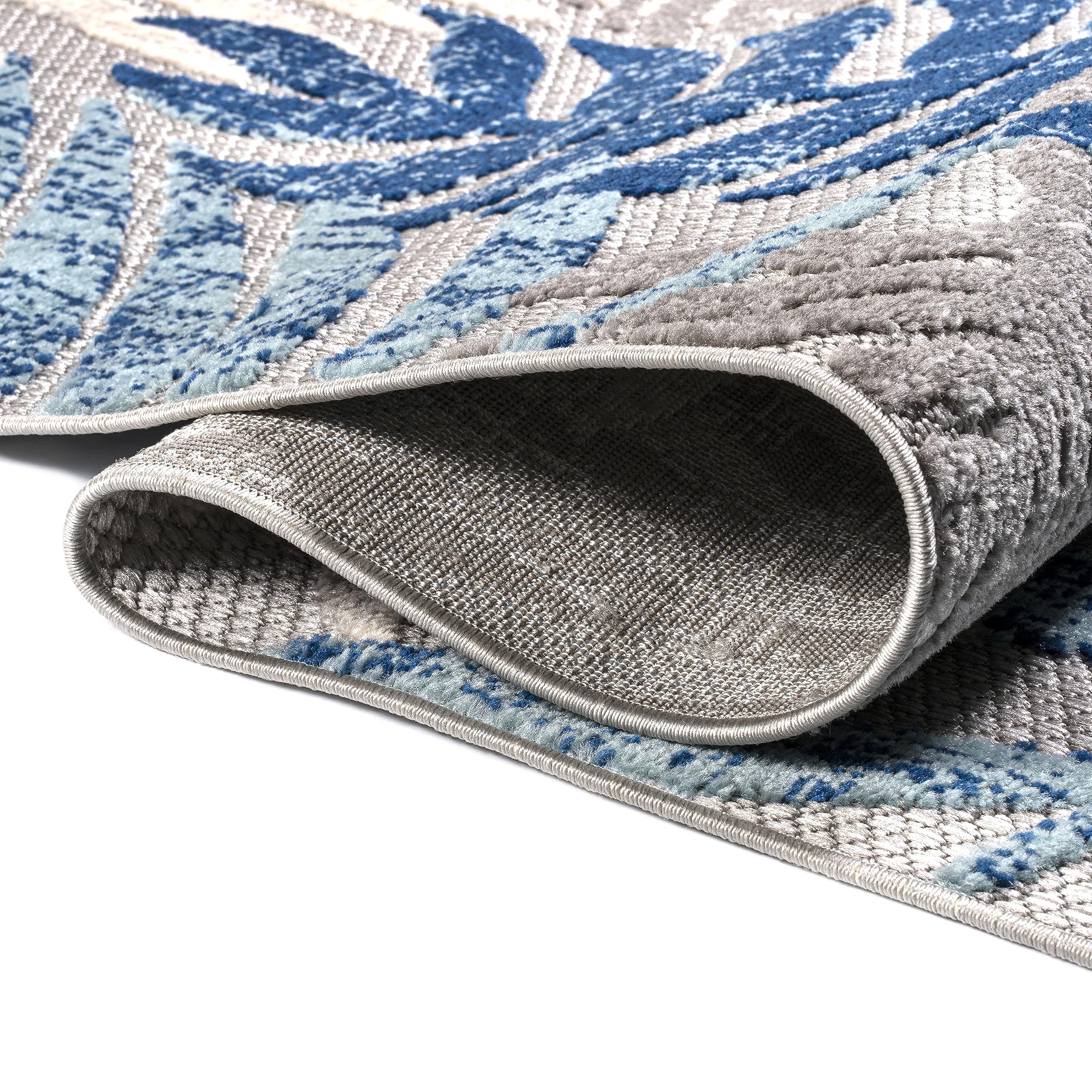 JONATHAN Y Tropics palm leaves rug close-up shows navy and khaki palette.