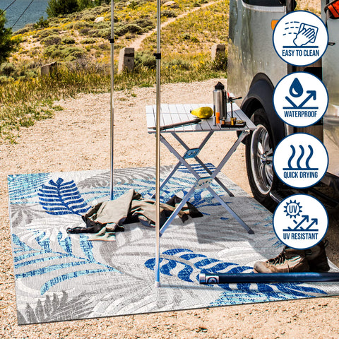 JONATHAN Y Tropics palm leaves rug outdoor setup with patio furniture highlights indoor-outdoor versatility.