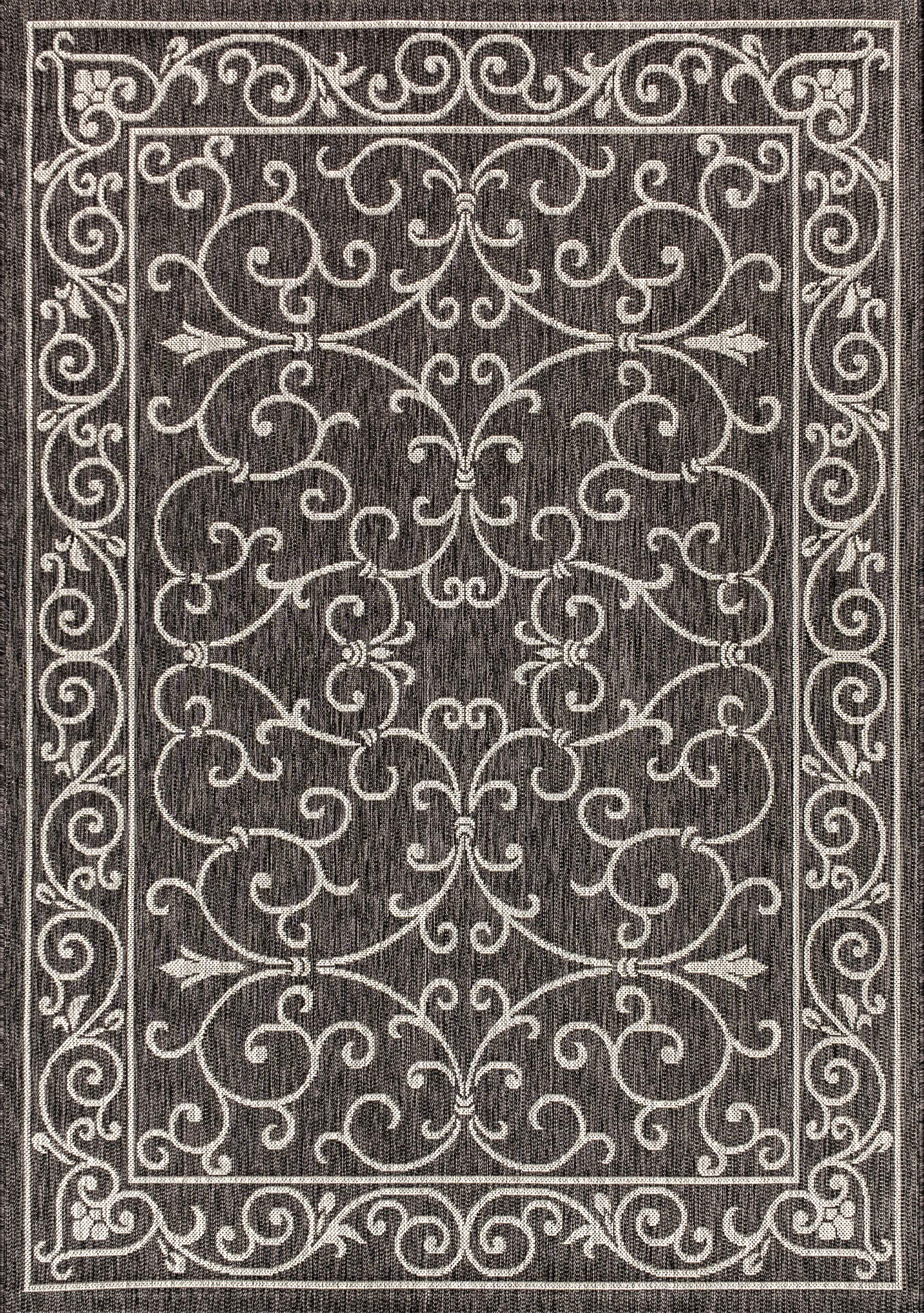Jonathan Y boho-chic outdoor rug, enhances backyard patios with moody black-gray tones.