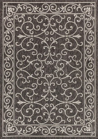 Jonathan Y boho-chic outdoor rug, enhances backyard patios with moody black-gray tones.