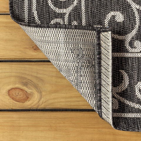 Jonathan Y 100% polypropylene rug, stain-resistant surface for quick cleanups on decks.