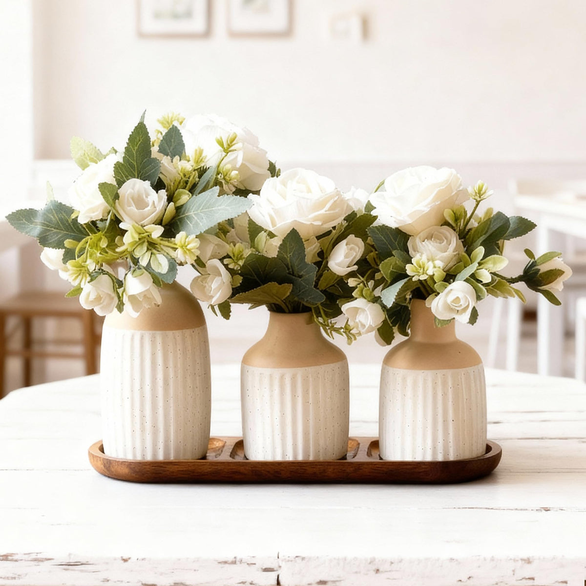 Jonronboci artificial flowers in ceramic vases with wood tray for a timeless centerpiece.