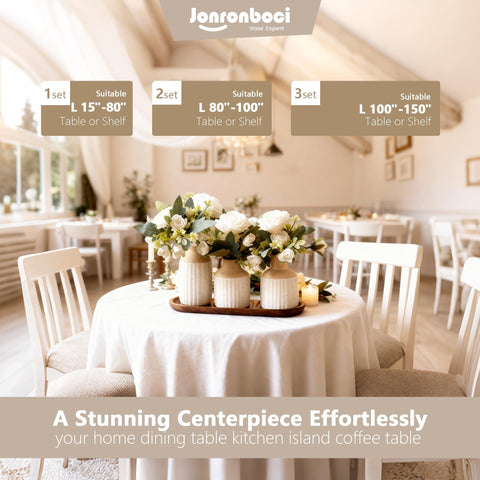 Jonronboci beige-white ceramic vases with floral centerpiece on table.