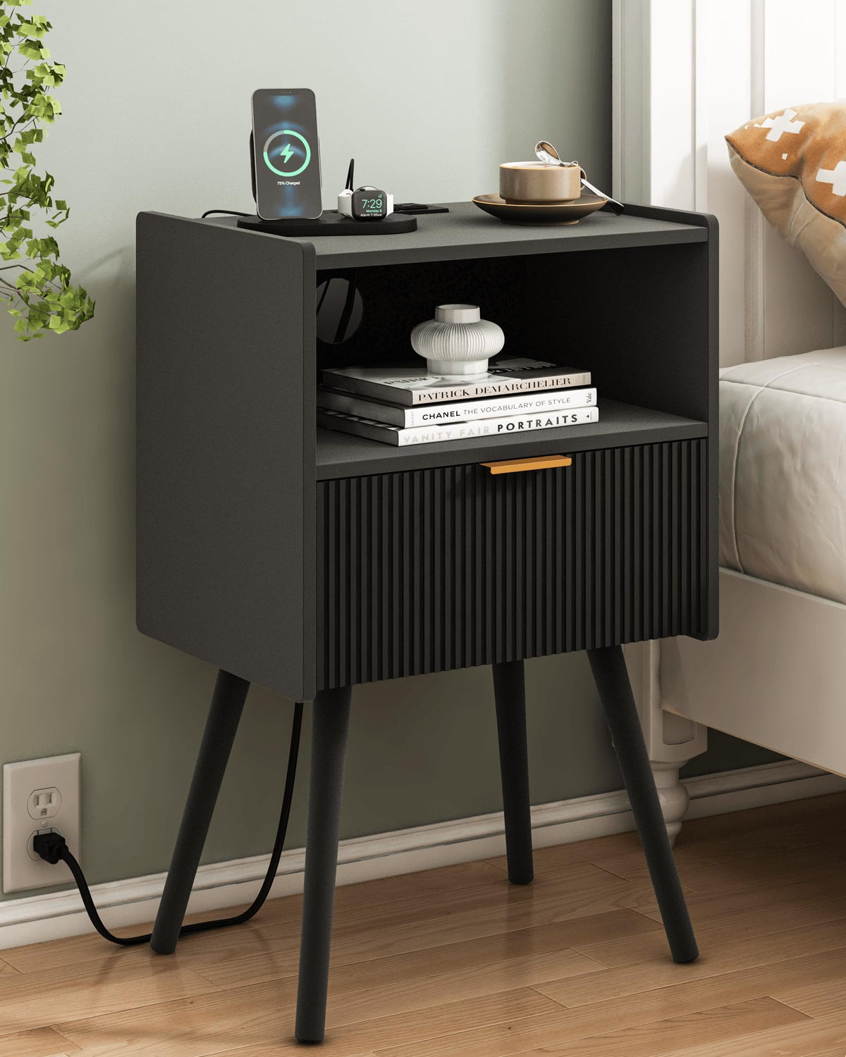 JOONEE black nightstand with outlet and drawer for bedside organization.