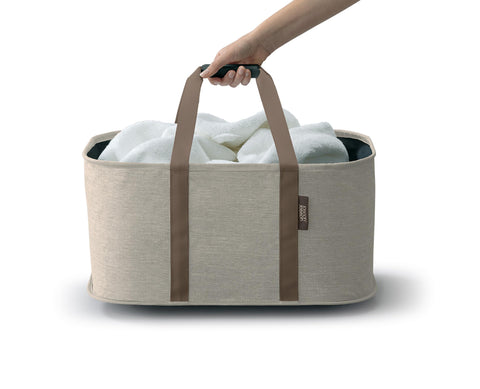 Joseph Joseph Hold-All in-use showing full laundry load ready to move