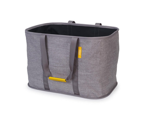 Joseph Joseph Hold-All Max, grey laundry basket with sturdy handles and 55L capacity.