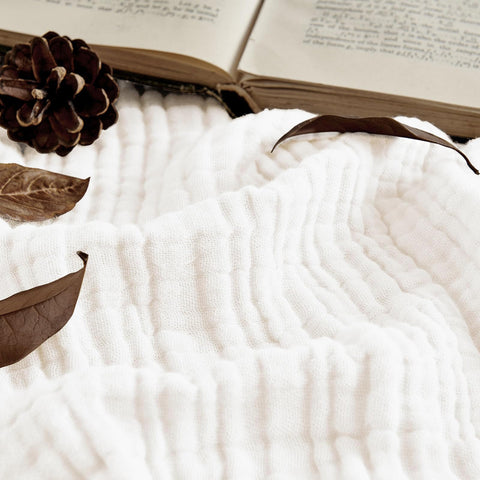 Folded Joydeco muslin throw highlights lightweight warmth and compact storage.