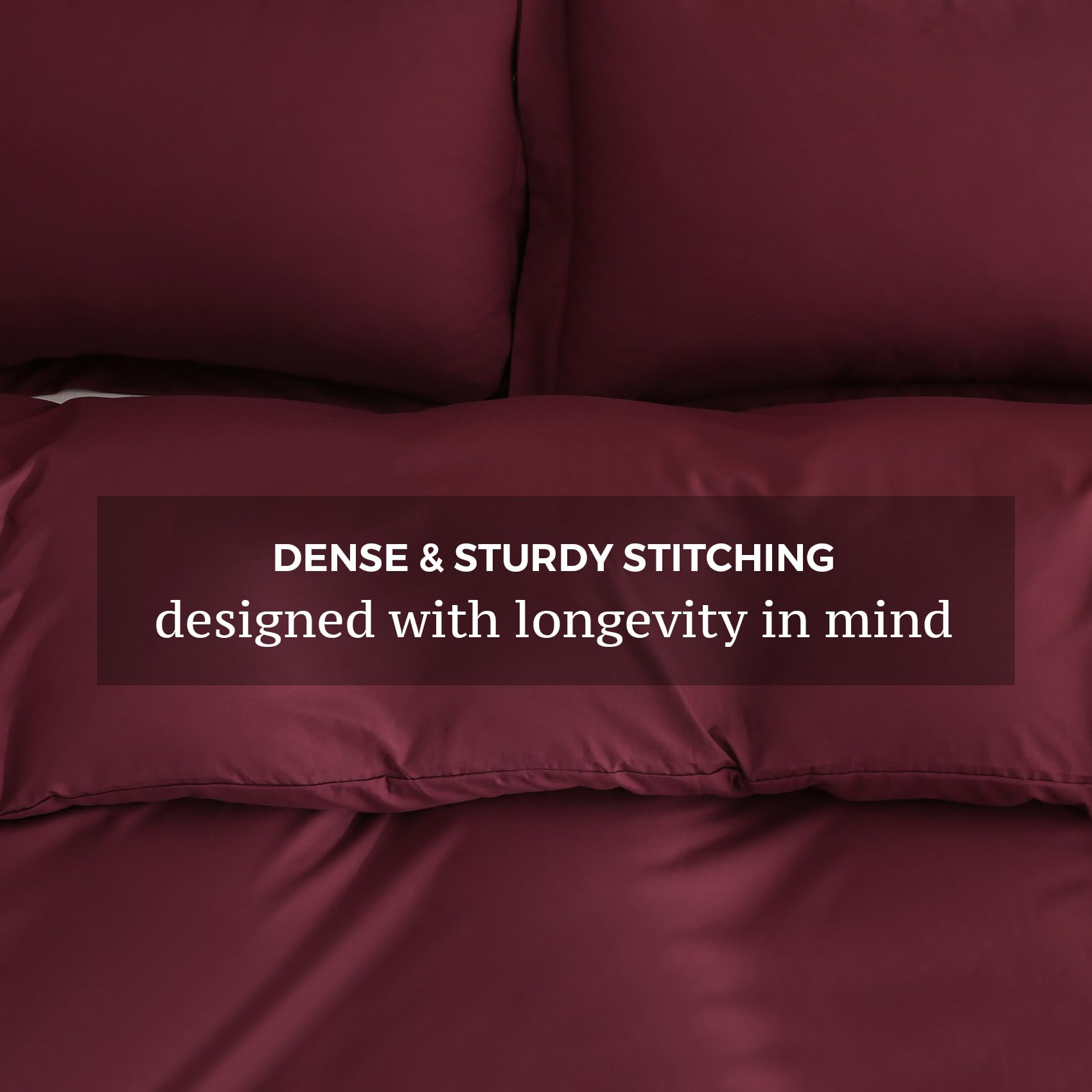 Two matching pillow shams with the JSD Burgundy 3-piece set on bed